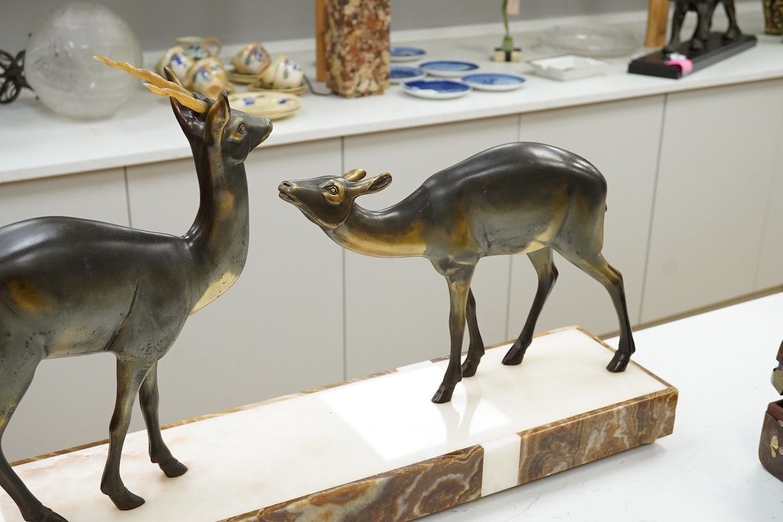 An Art Deco spelter and marble stag and deer group, 70cm wide